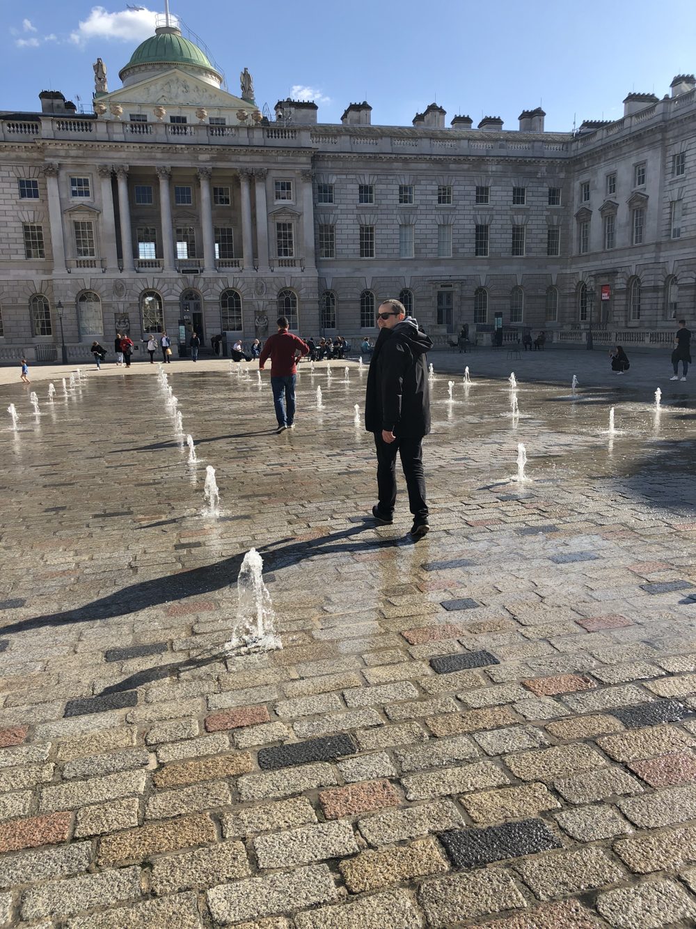 Michael walking through the fountains at Somerset House in London